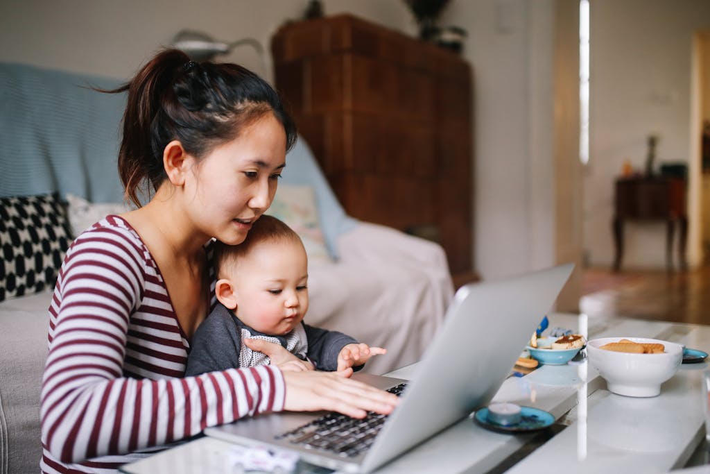 Woman with baby at computer