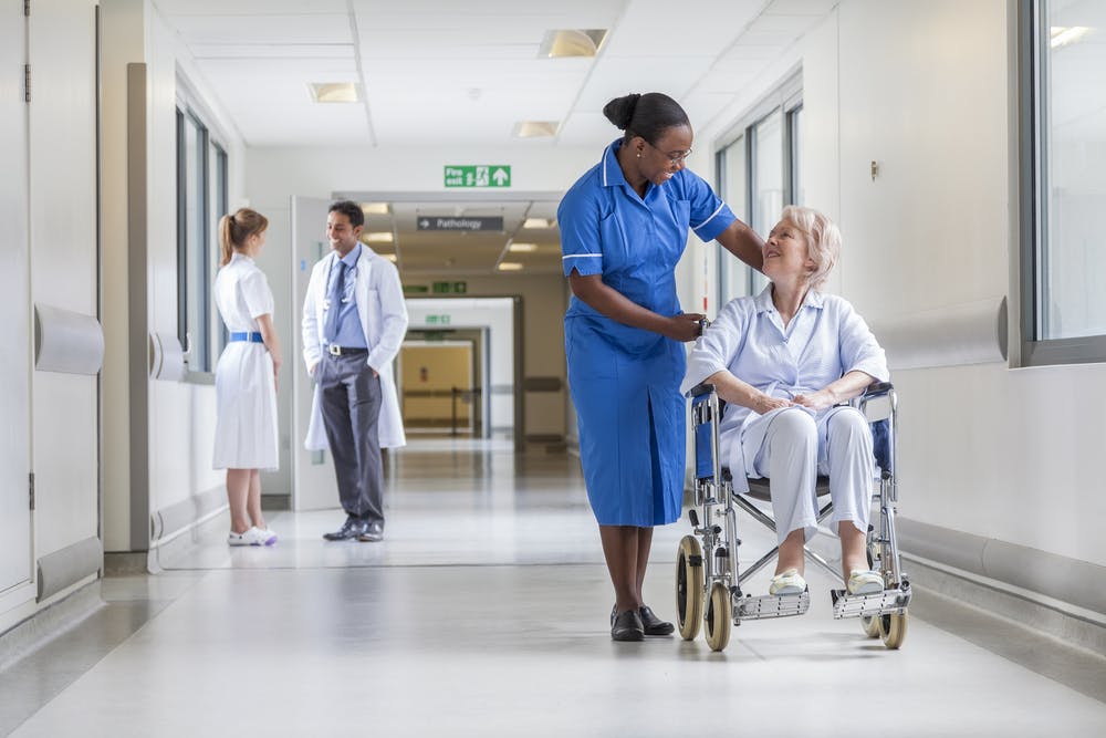 Nurse helps orthopaedic patient in London hospital
